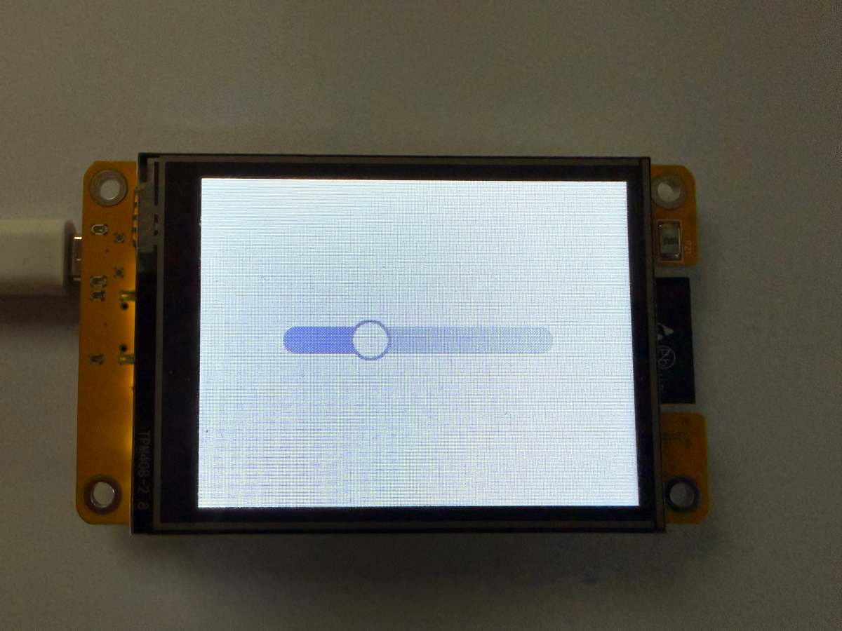 Photo of a physical slider widget on a display dimming a light