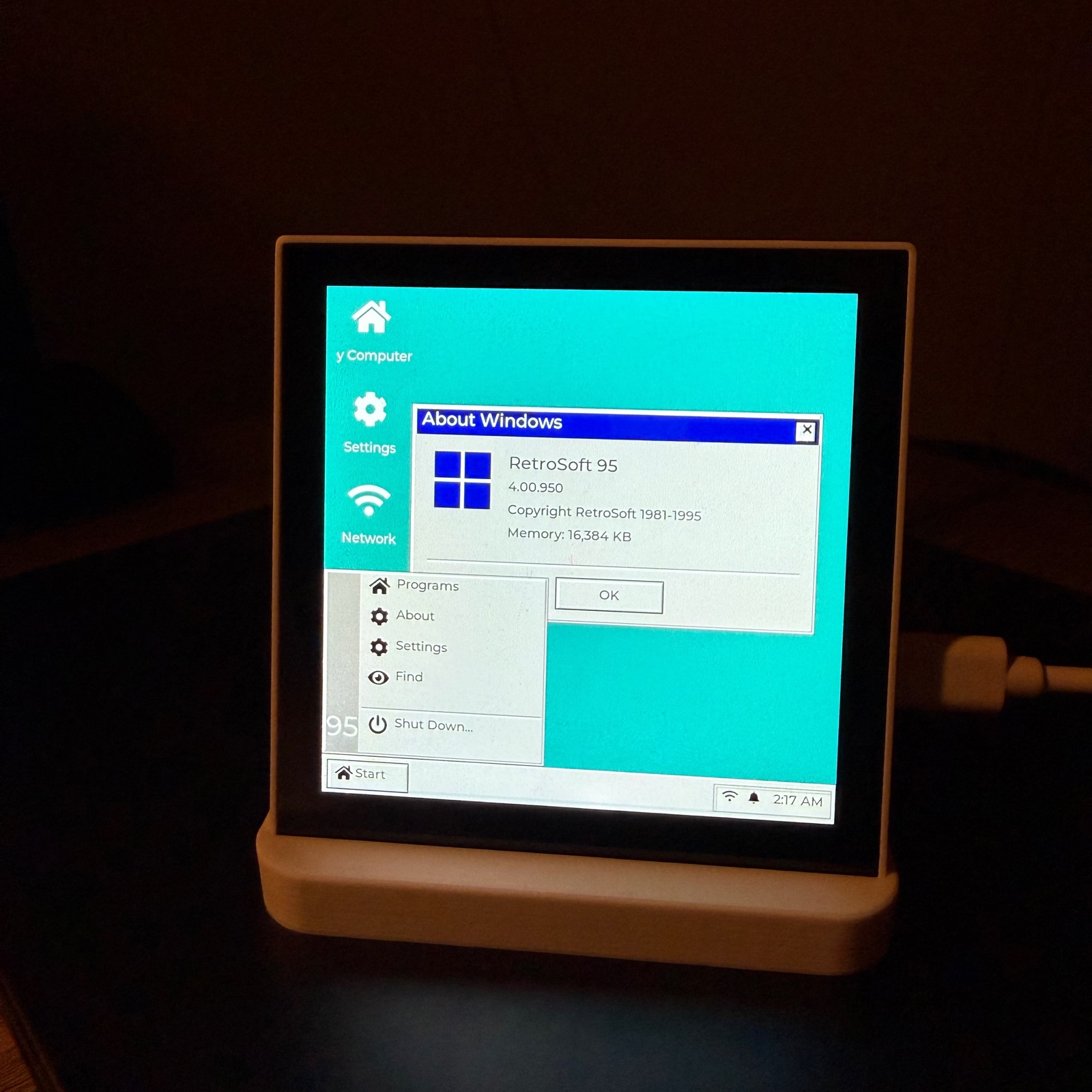Retro desktop with an About window and taskbar on an ESP32 panel